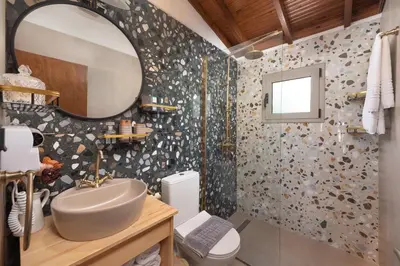 a bathroom with a sink and a mirror at Ilaira Sea View Bungalow in Gennadi