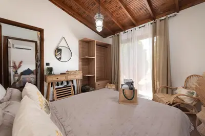 a bedroom with a bed with a camera on it at Ilaira Sea View Bungalow in Gennadi