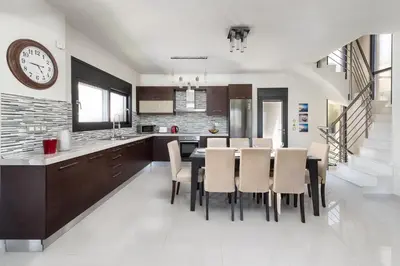 a kitchen and dining room with a table and chairs at Ixia Breeze 3 in Ixia