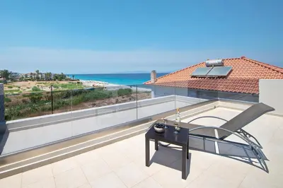 a balcony with a table and a view of the ocean at Ixia Breeze 3 in Ixia