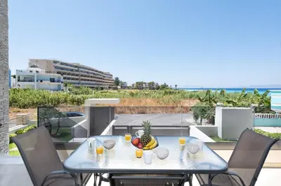 a table with a bowl of fruit on a balcony at Ixia Breeze 3 in Ixia