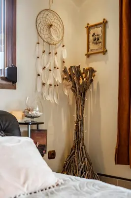 a room with a wall with a rack of hats at Colonial View Apartment in Faliraki