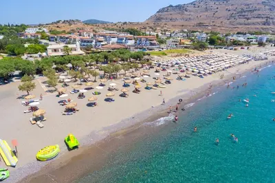 an aerial view of a beach with a crowd of people at Sun Beach Lindos in Lardos