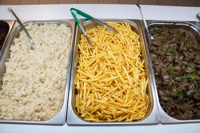 a tray of food with spaghetti and other food items at Sun Beach Lindos in Lardos