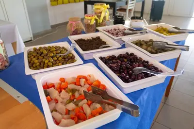 a table topped with trays of different types of food at Sun Beach Lindos in Lardos