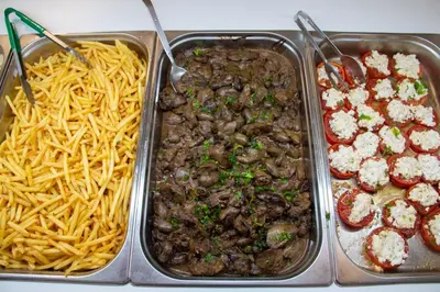 a tray of food with pasta and meat and cheese at Sun Beach Lindos in Lardos