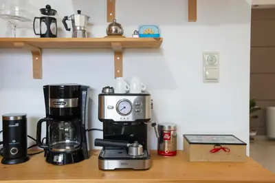 a counter with a coffee maker and a coffeemaker at Seascape Village - Spacious 3-Bed Apartment with Private Garden and Parking in Kalithies