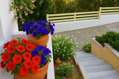 two pots of flowers on a wall in a garden at Seascape Village - Spacious 3-Bed Apartment with Private Garden and Parking in Kalithies