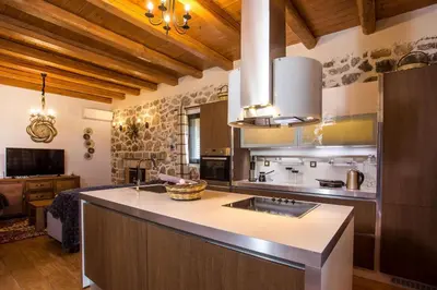 a kitchen with a sink and a counter top at Villa in the Woods in Kolimbia