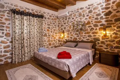 a bedroom with a bed with a red bag on it at Villa in the Woods in Kolimbia