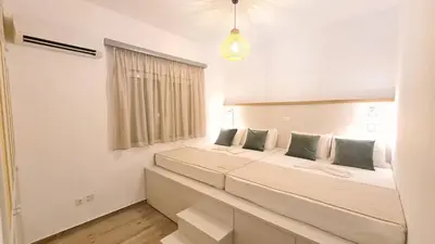two beds in a room with a window at Villa Stamos with Seaview and Private Pool - Partner of Prasonisi Villas in Plimmiri