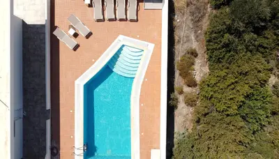 an overhead view of a swimming pool on a building at Villa Stamos with Seaview and Private Pool - Partner of Prasonisi Villas in Plimmiri