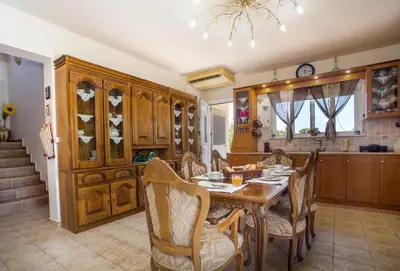 a kitchen with a table and chairs and a dining room at Laylande House in Theologos