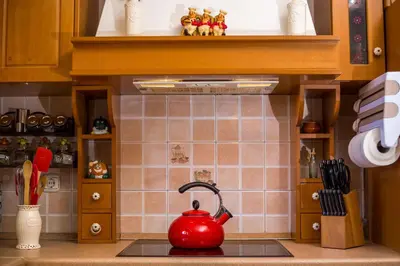 a kitchen with a red tea kettle on the stove at Laylande House in Theologos