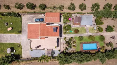an overhead view of a house with a swimming pool at Laylande House in Theologos