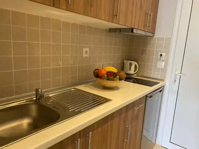a kitchen with a sink and a bowl of fruit at Stegna Premium in Archangelos