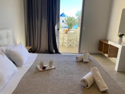 a bedroom with towels and cups on a bed at Stegna Premium in Archangelos