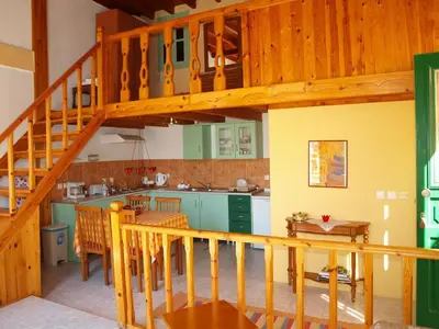 a kitchen with a wooden staircase in a house at Andreas Apartments in Symi