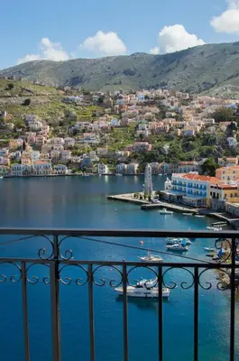 a view of a harbor with boats in a body of water at Andreas Apartments in Symi