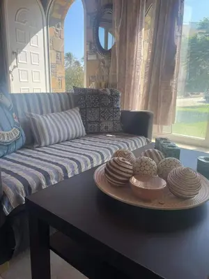 a living room with a couch and a table with plates of food at Kiotari Stone House in Gennadi