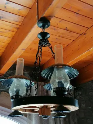 a chandelier hanging from a wooden ceiling at Kiotari Stone House in Gennadi