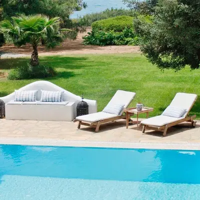 two lounge chairs and a couch next to a pool at Villa Blue Sapphire in Pefki Rhodes