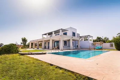 a house with a swimming pool in front of it at The 