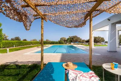 a view of a swimming pool from the patio of a house at The 