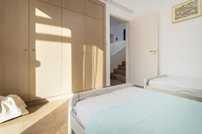a bedroom with two beds and a staircase at The 