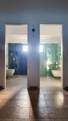 a bathroom with two sinks and two toilets at The 