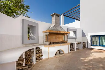 an external view of a house with an outdoor fireplace at The 