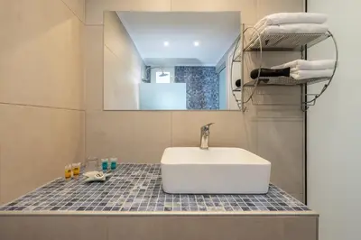 a bathroom with a white sink on a counter at Bivalvia Studios in Faliraki