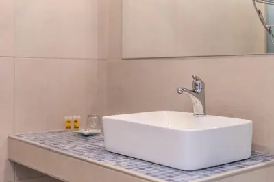 a white sink sitting on a counter in a bathroom at Bivalvia Studios in Faliraki
