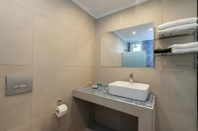 a bathroom with a sink and a mirror at Bivalvia Studios in Faliraki