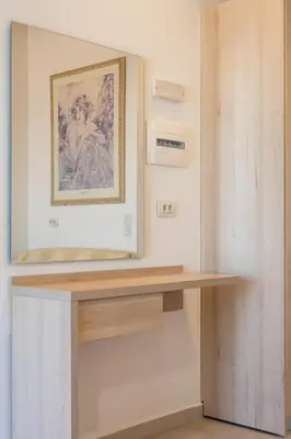 a table in a room with a painting on the wall at Bivalvia Studios in Faliraki