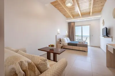 a living room with a couch and a bed at Bivalvia Studios in Faliraki