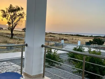 a view of the beach from the balcony of a house at Kelly's Beach House 2 in Gennadi