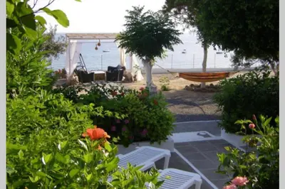 a garden with a hammock and a view of the ocean at Villa Tsampika in Pefki Rhodes
