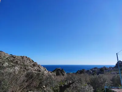 a view of the ocean from the road at Ioli's Apartments in Archangelos