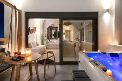 a bathroom with a tub and a living room at Pefkos Allure Luxury Suites with Jacuzzi in the heart of Pefkos!!! in Pefki Rhodes