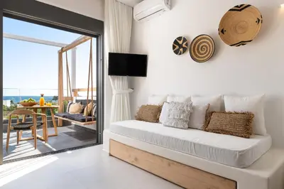 a bedroom with a bed and a view of the ocean at Pefkos Allure Luxury Suites with Jacuzzi in the heart of Pefkos!!! in Pefki Rhodes