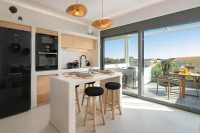 a kitchen with a white counter and a large window at Pefkos Allure Luxury Suites with Jacuzzi in the heart of Pefkos!!! in Pefki Rhodes