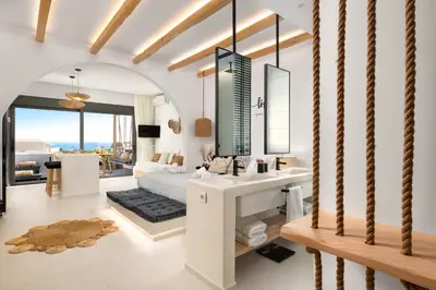 a bathroom with a sink and a bed in a room at Pefkos Allure Luxury Suites with Jacuzzi in the heart of Pefkos!!! in Pefki Rhodes