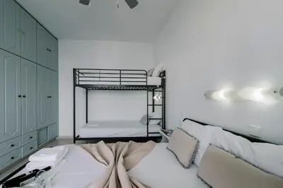 a bedroom with two bunk beds and a white wall at Mike's Studios in Haraki