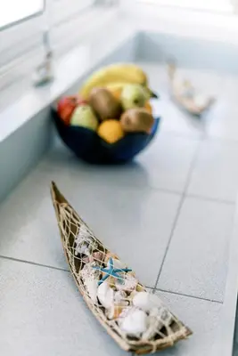 a bowl of fruit sitting on a kitchen counter at Mike's Studios in Haraki