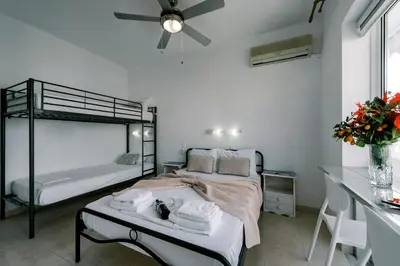 a bedroom with a bed with towels on it at Mike's Studios in Haraki