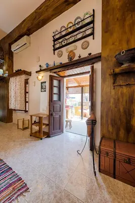 a living room with a door and a table at Hara's Traditional Detached House in Malona in Malona Village