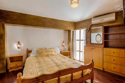a bedroom with a large bed and a window at Hara's Traditional Detached House in Malona in Malona Village