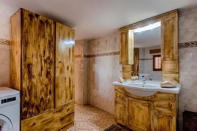a bathroom with a sink and a washing machine at Hara's Traditional Detached House in Malona in Malona Village