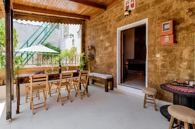 a patio with a table and chairs and a balcony at Hara's Traditional Detached House in Malona in Malona Village